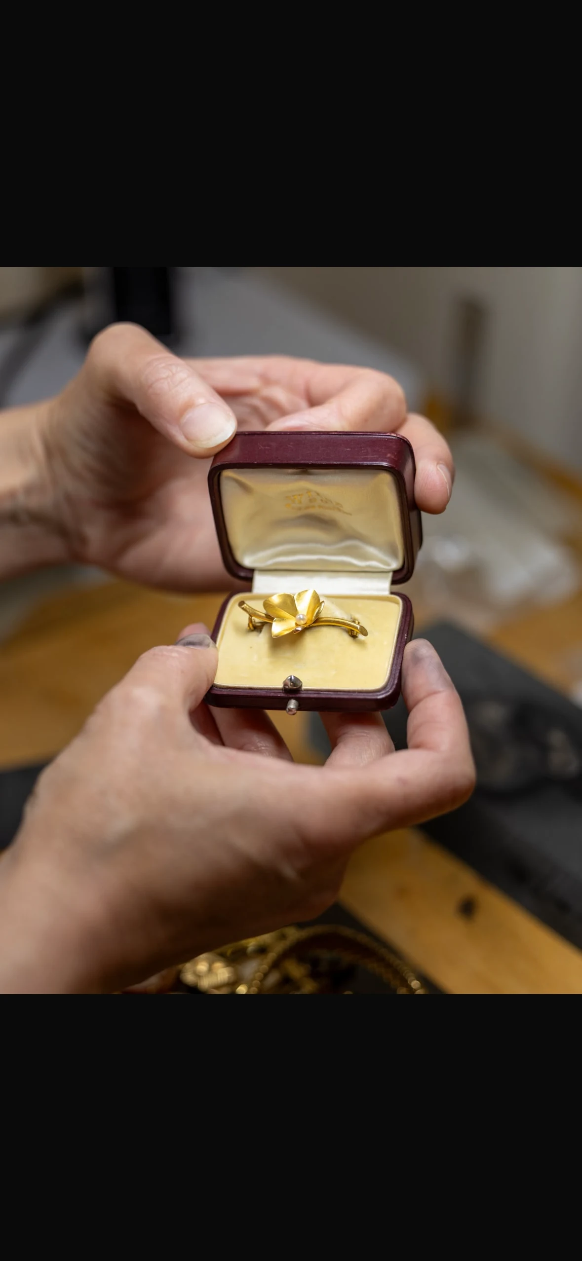 The antique brooch in its case